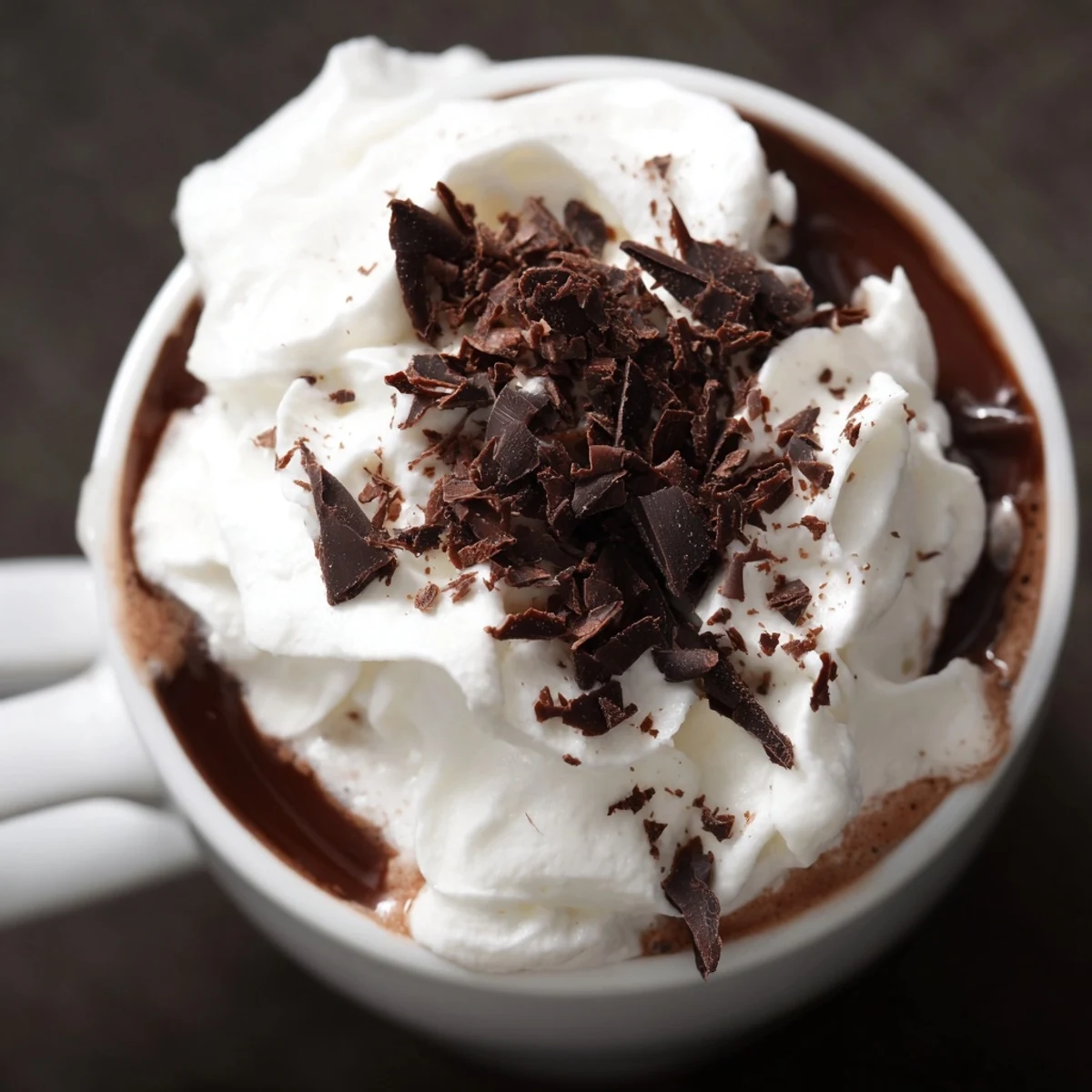 Spiced Hot Chocolate with Whipped Topping topped with billowy whipped cream and a dusting of cocoa.