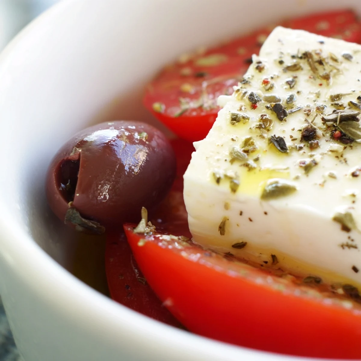 Chilled Greek salad with Kalamata olives and feta, loaded with tomatoes, cucumber, red onion, and green bell pepper.