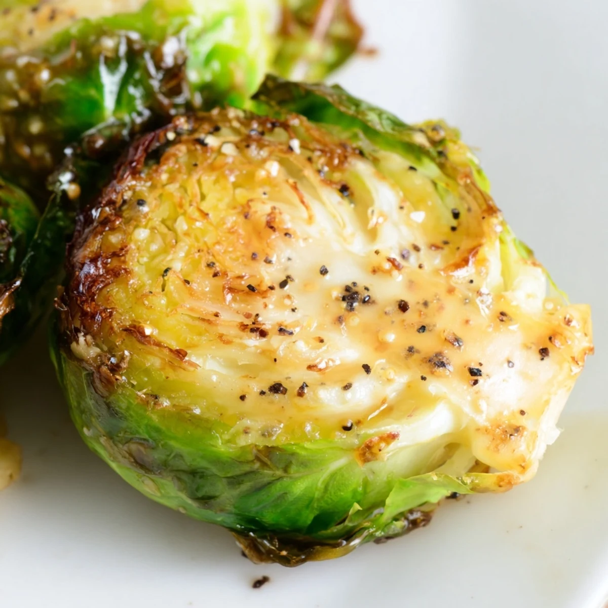 Freshly roasted Brussels Sprouts with Balsamic glaze served hot alongside a main course, ready to enjoy. Easy and flavorful.