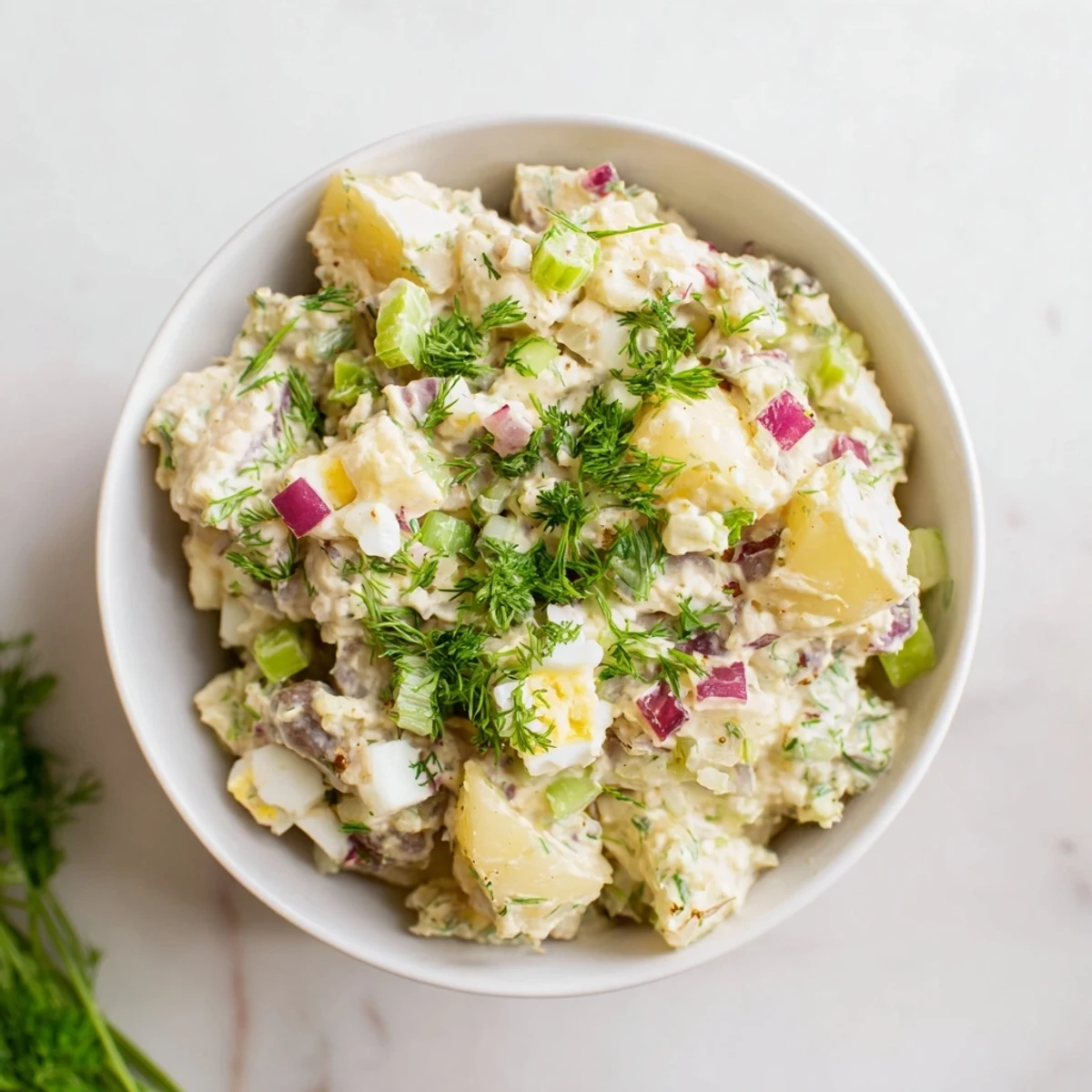 This classic American creamy potato salad features tender Yukon Gold potatoes coated in tangy mayonnaise and Dijon dressing, ideal for picnics and potlucks.  