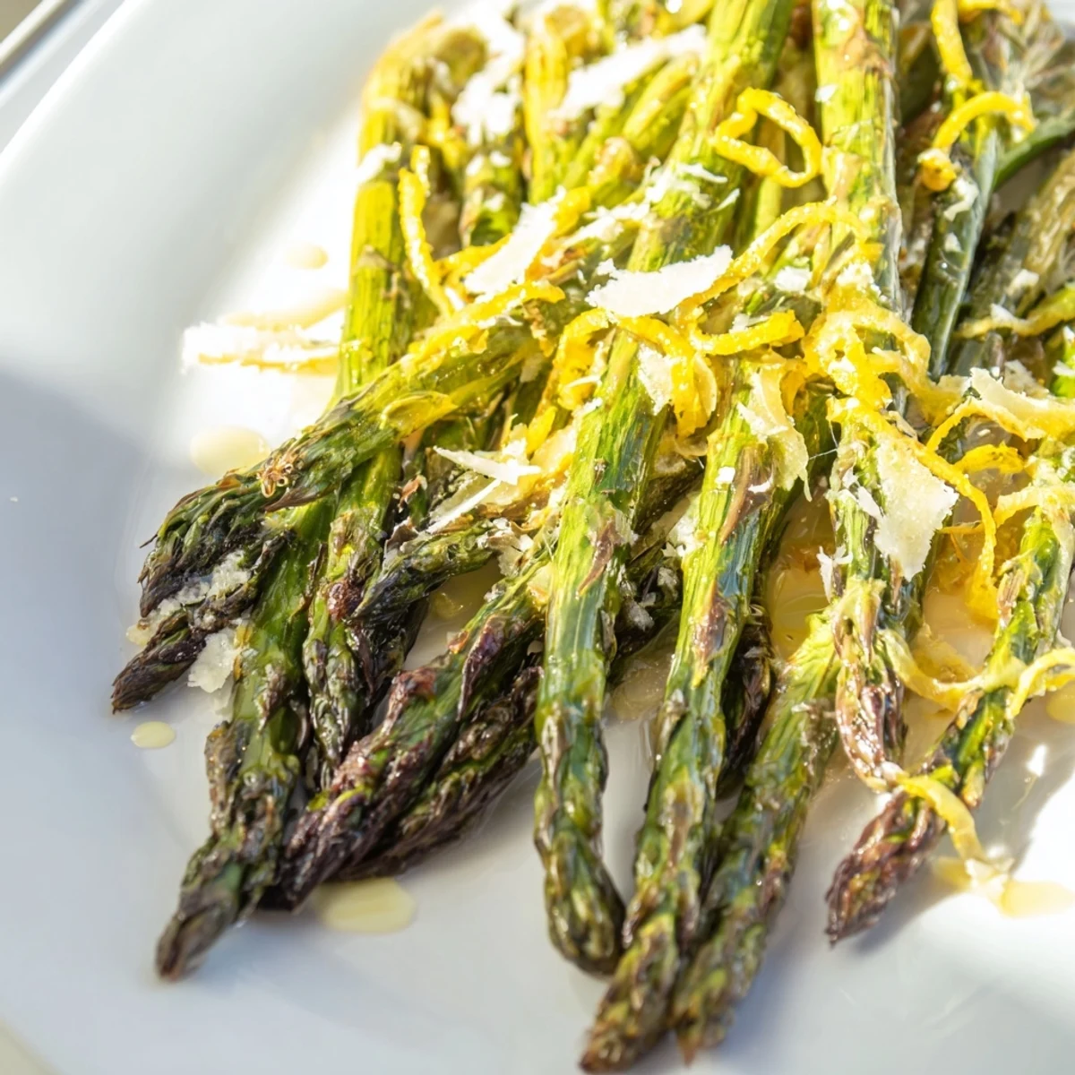 Fresh roasted asparagus with lemon and Parmesan, garnished with zest and cheese, ready to enjoy.