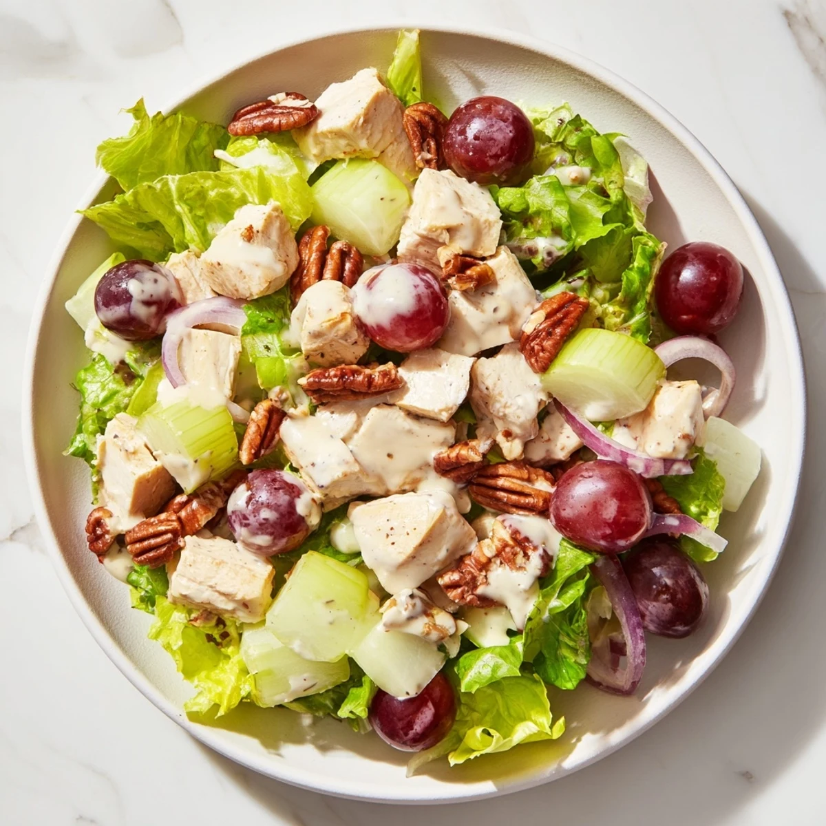 Crisp mixed greens topped with tender diced chicken, juicy halved grapes, and toasted pecans, all tossed in creamy homemade dressing.  