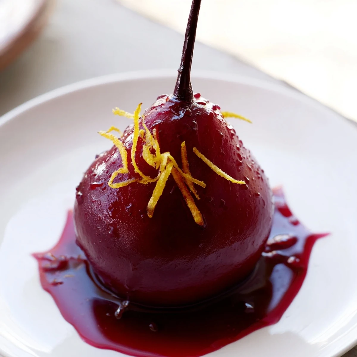 Elegant Romantic Poached Pears in Grape Juice garnished with fresh mint and a drizzle of reduced syrup, ideal for special occasions.