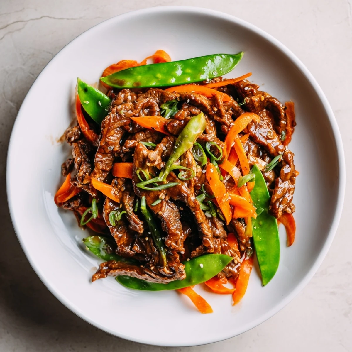 Tender beef strips, crisp snow peas, and carrots in a glossy sauce for Beef Stir Fry with Snow Peas and Carrots.