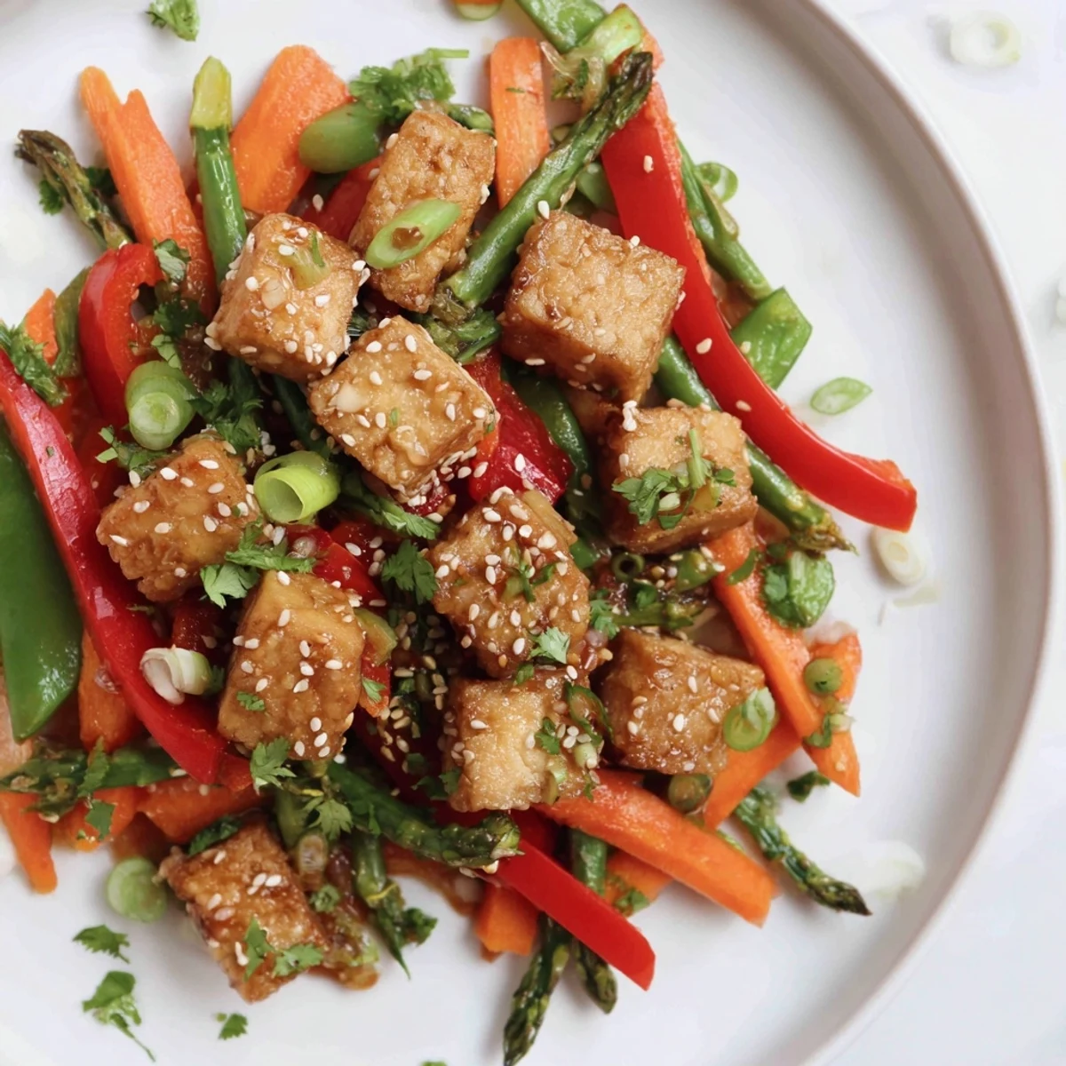 Freshly cooked Spring Vegetable Stir Fry with Tofu garnished with sesame seeds and cilantro, ready for a quick weeknight dinner.