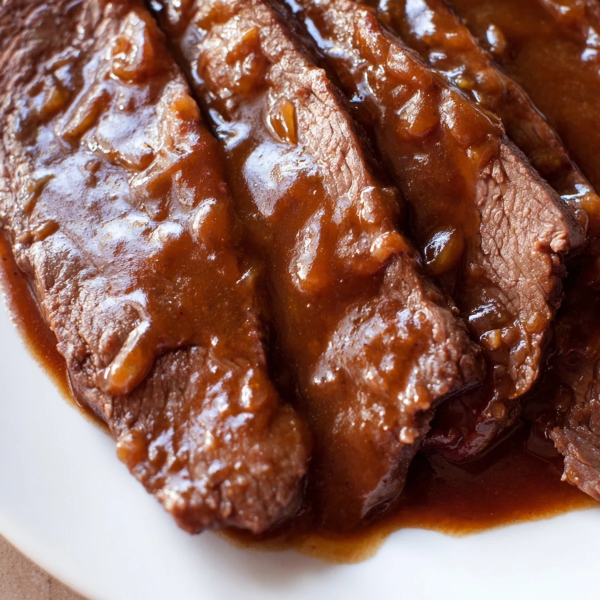 A close-up of Ultimate Slow Cooker Mongolian Beef simmered in a rich sauce with green onions, ready to be served hot.