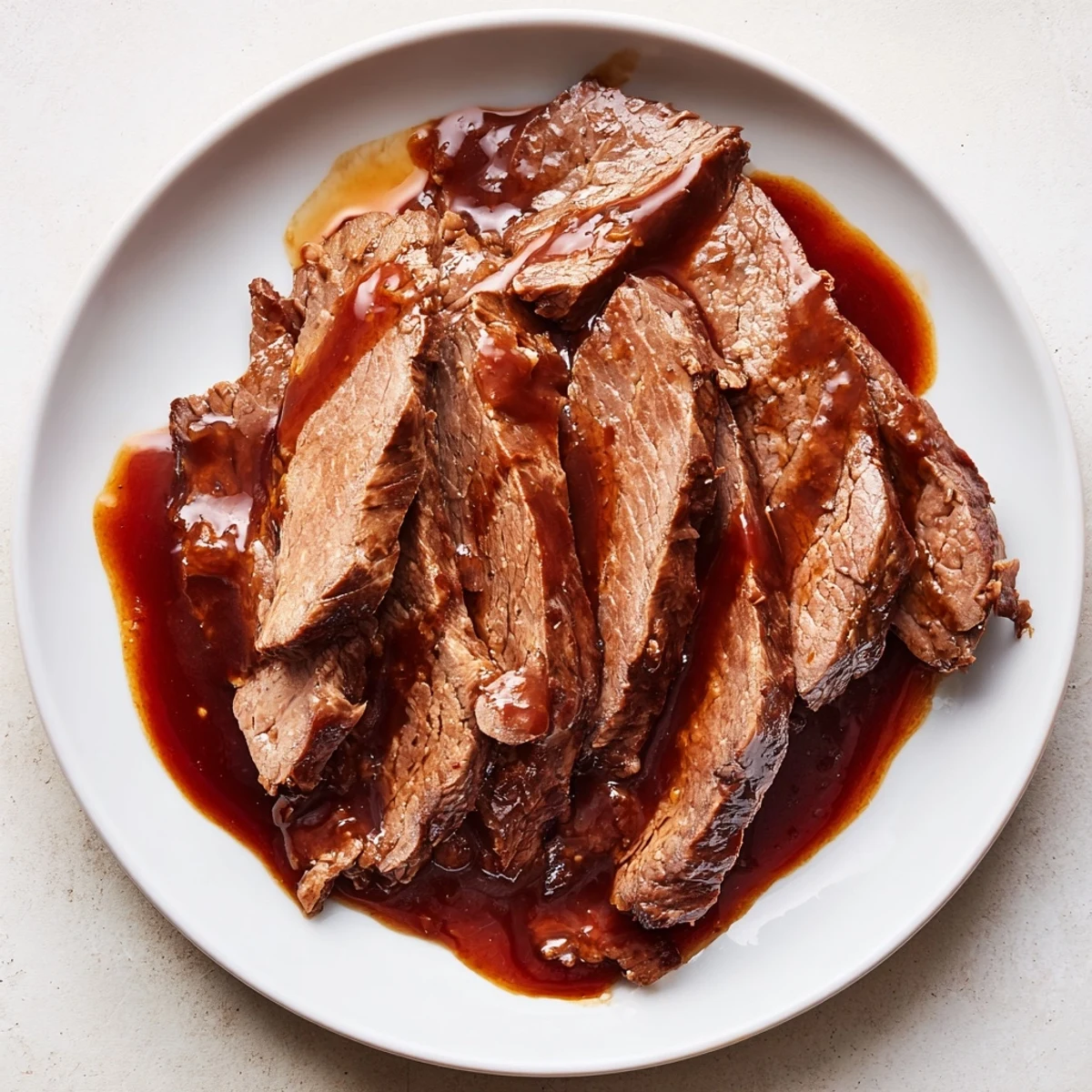 Family-style platter of Ultimate Slow Cooker Mongolian Beef paired with broccoli, showcasing glossy, caramelized slices perfect for weeknight dinners.