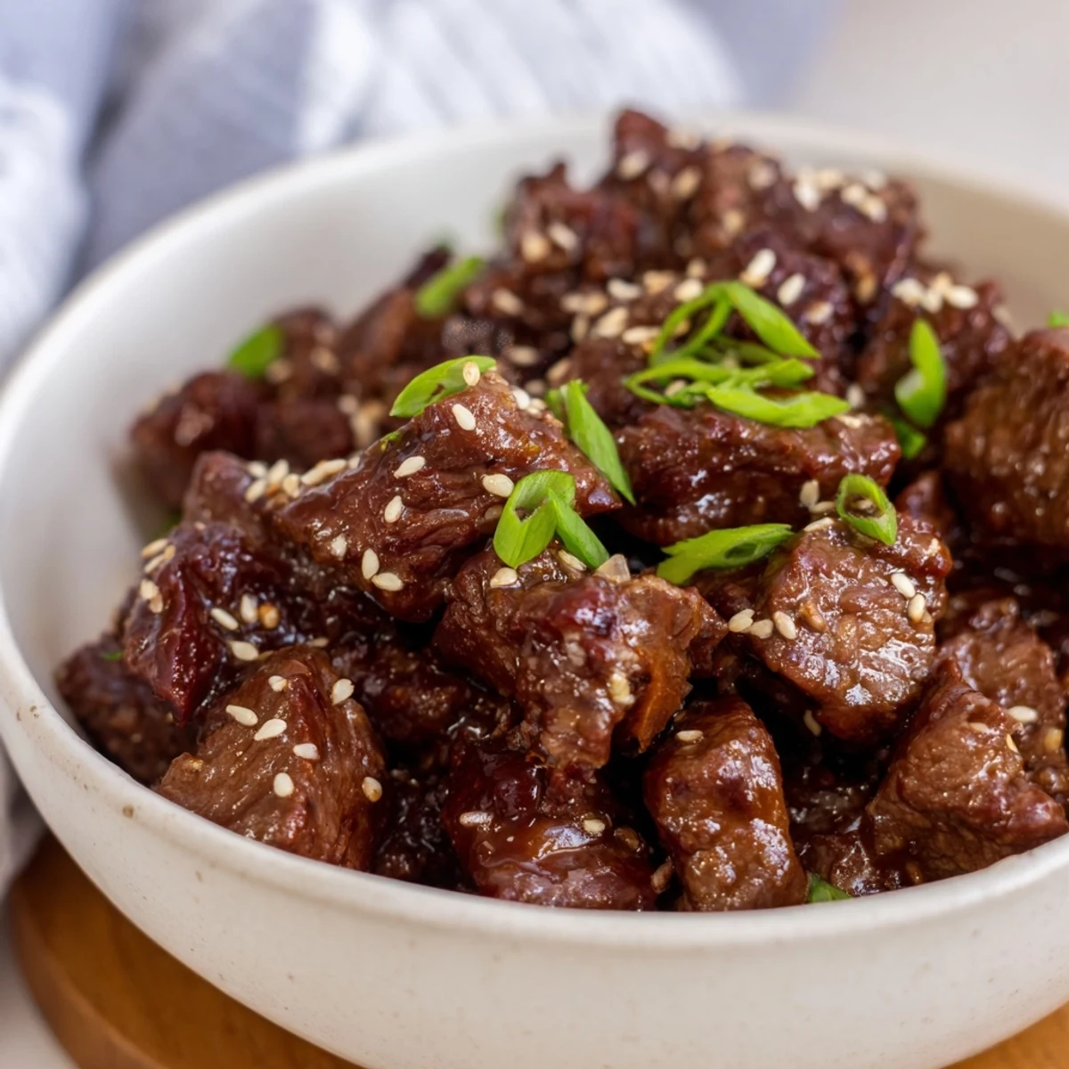 Family-style Crock Pot Korean Beef in lettuce wraps, topped with sesame seeds and scallions.