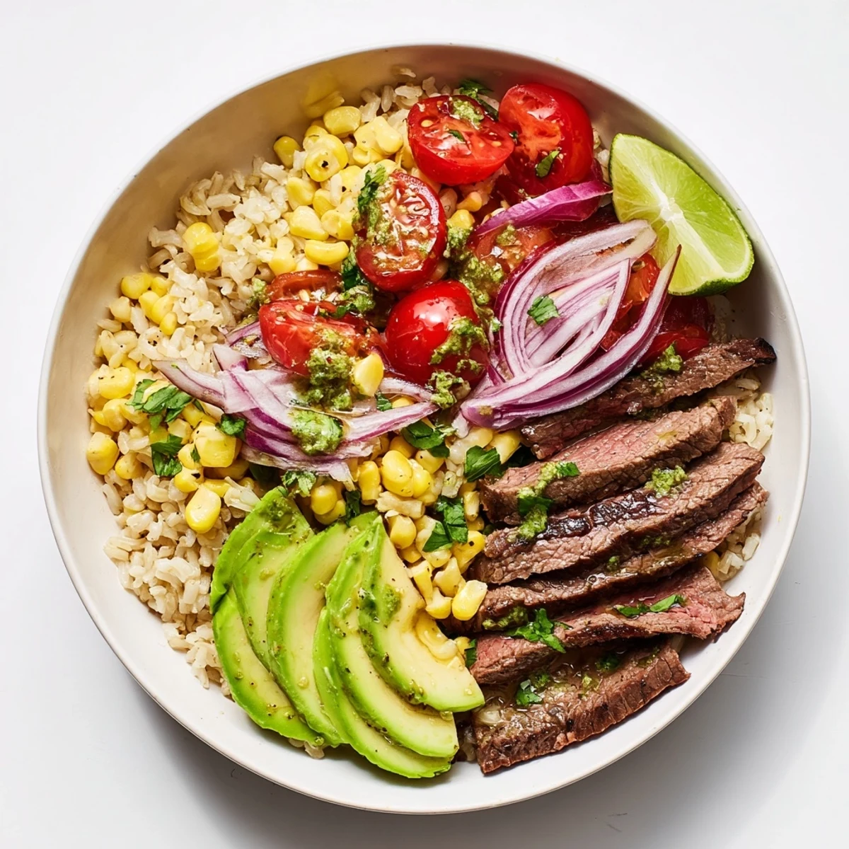 Fresh ingredients for the Steak Avocado Roasted Corn Bowl include sliced steak, avocado, and roasted corn, served in a colorful ceramic bowl.