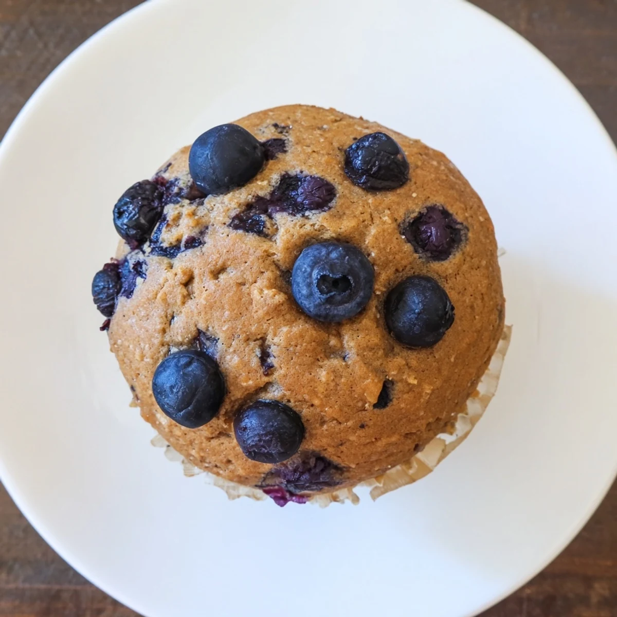 Stack of warm Greek Yogurt Blueberry Protein Muffins, drizzled with honey and served alongside a glass of milk for a perfect healthy breakfast.