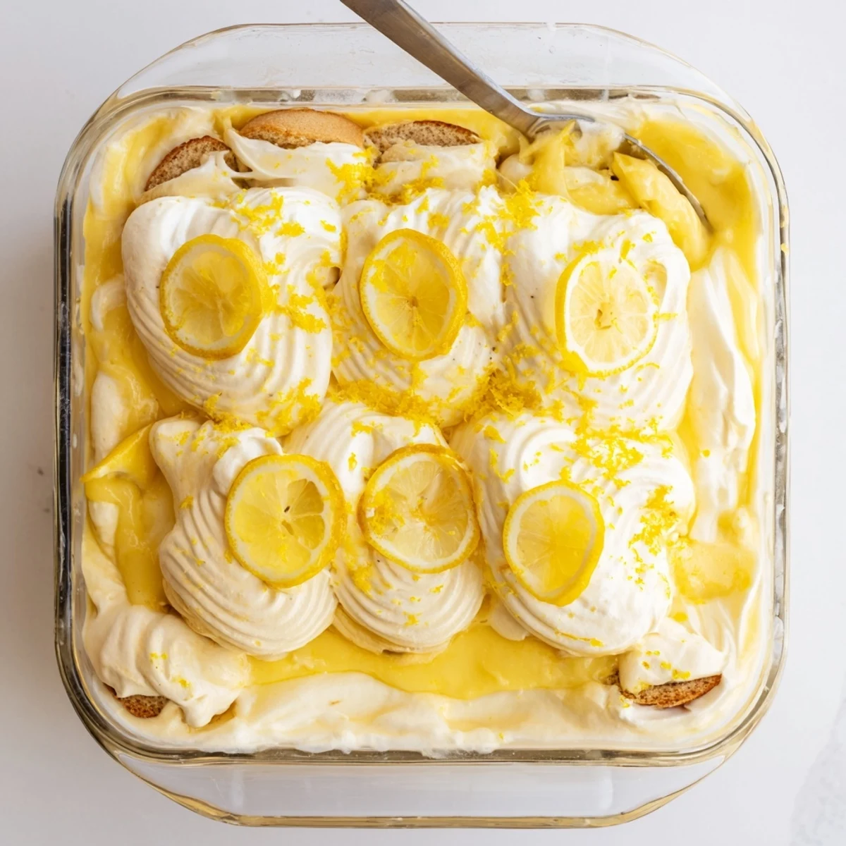 Side angle photo of Lemon Limoncello Italian Tiramisu, showing the rich texture of limoncello-soaked ladyfingers and lemon curd swirls.