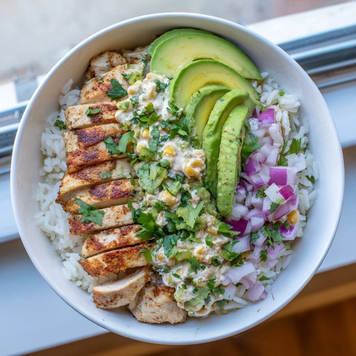 Sliced juicy chicken, charred corn, fluffy rice, and cotija cheese create a colorful and satisfying Street Corn Chicken Rice Bowl.