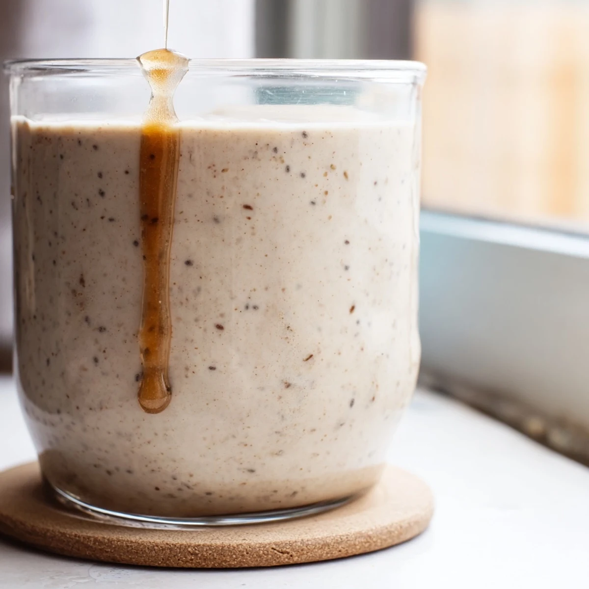 Protein-packed Greek yogurt banana smoothie with honey drizzle and cinnamon topping ready for breakfast
