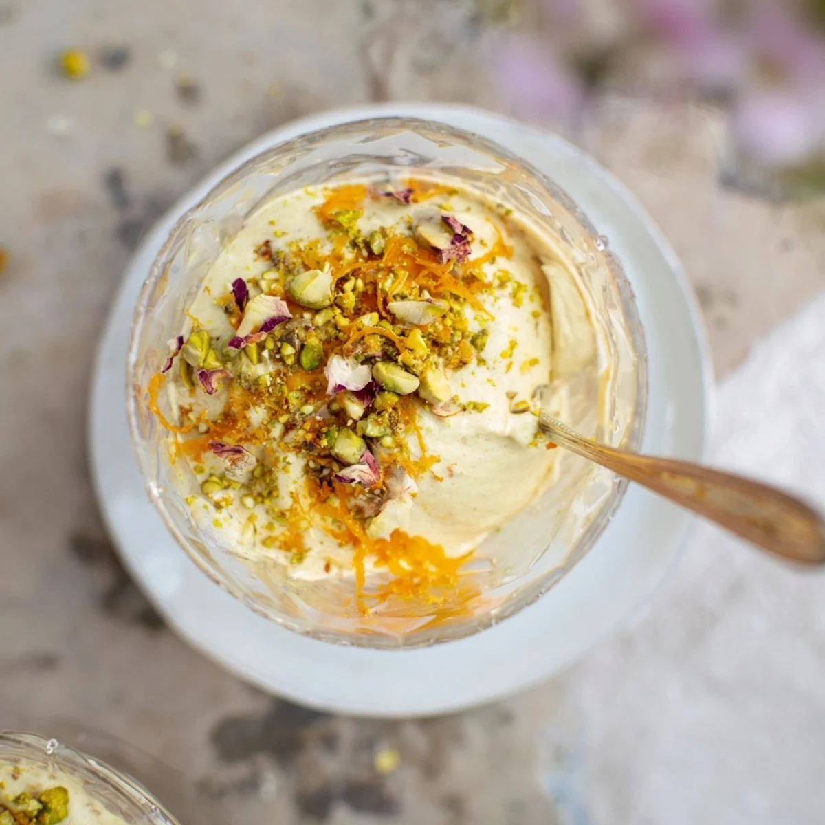 Creamy Lebanese date blossom mousse garnished with chopped pistachios and fragrant orange zest