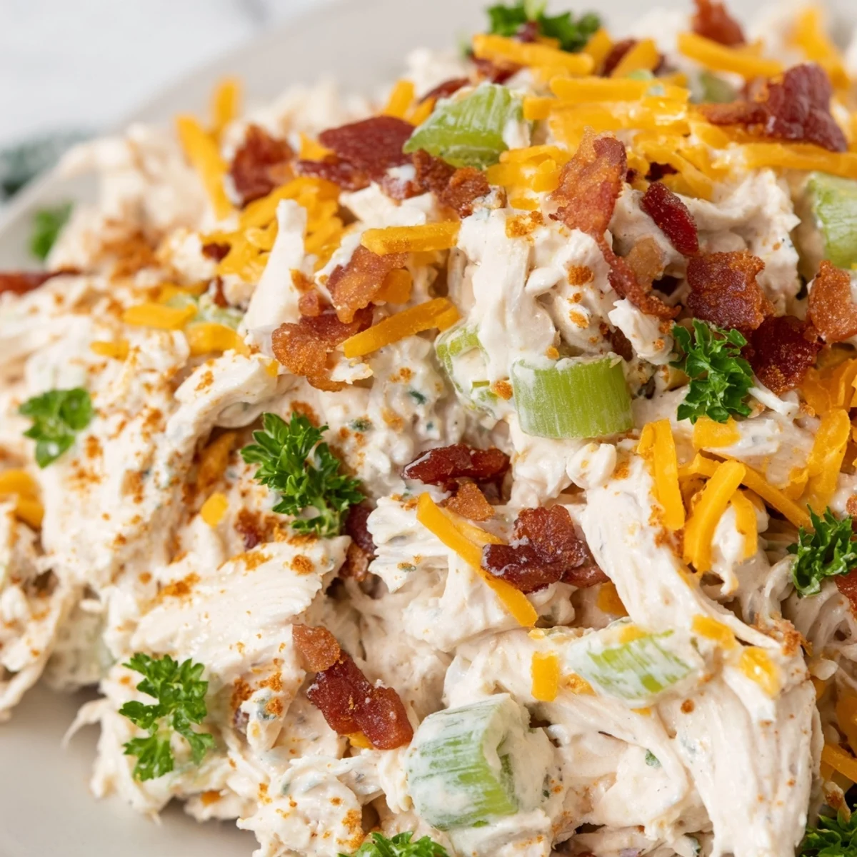 Chilled low carb jalapeno popper cottage cheese chicken salad scooped onto crisp lettuce leaves for a gluten-free lunch