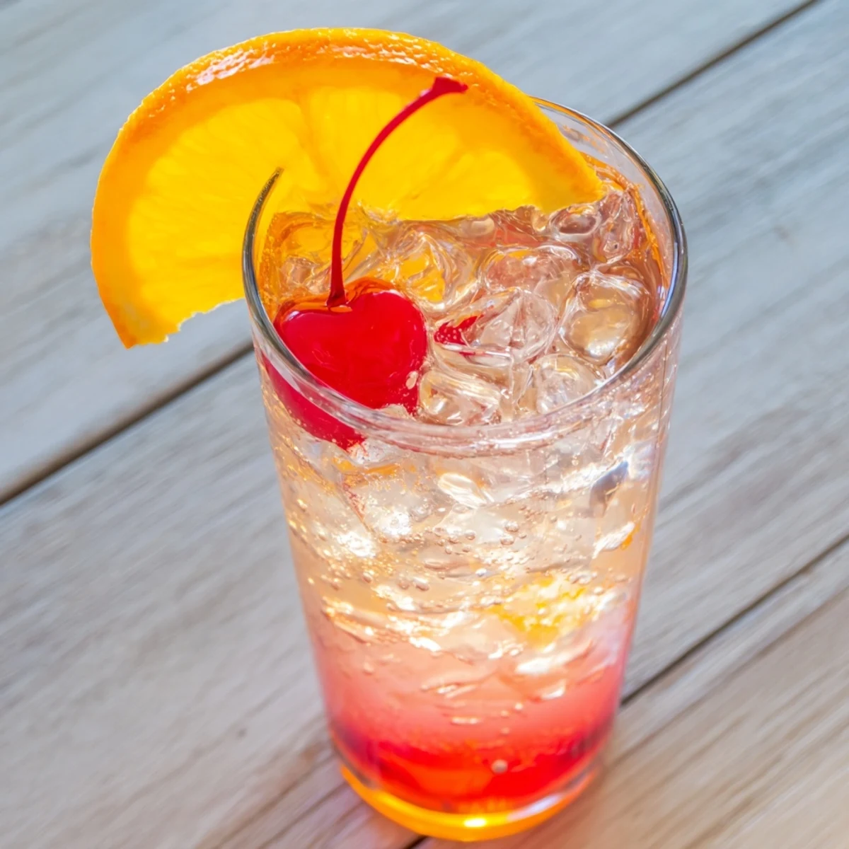 Refreshing Easy Shirley Temple Drink served over ice in clear glass with orange slice garnish on rim