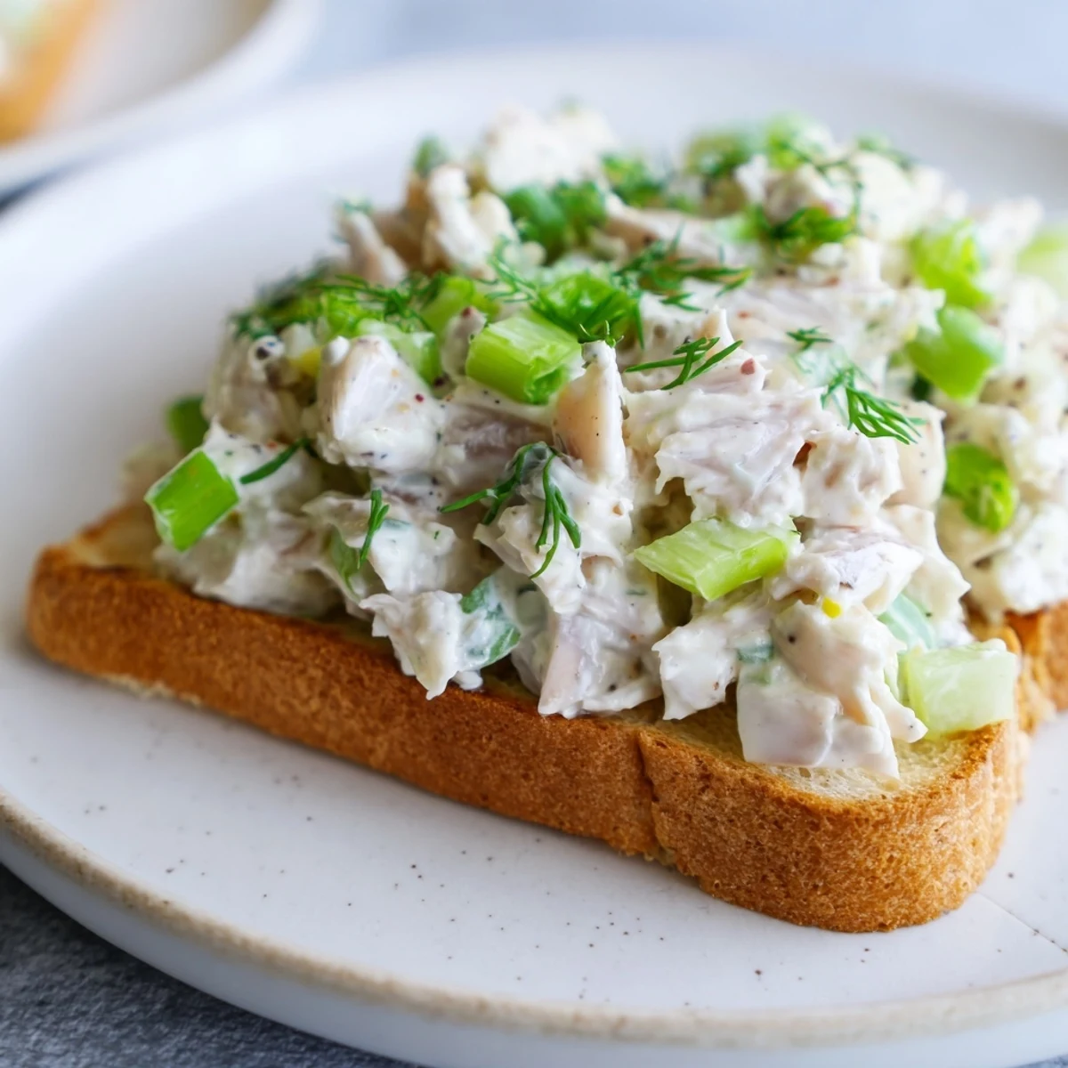 Golden sourdough toast piled high with creamy crab salad and fresh herbs