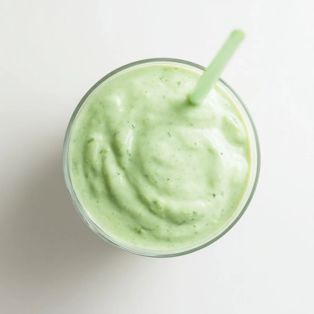 Creamy Greek yogurt avocado smoothie poured into tall glasses with vibrant green color