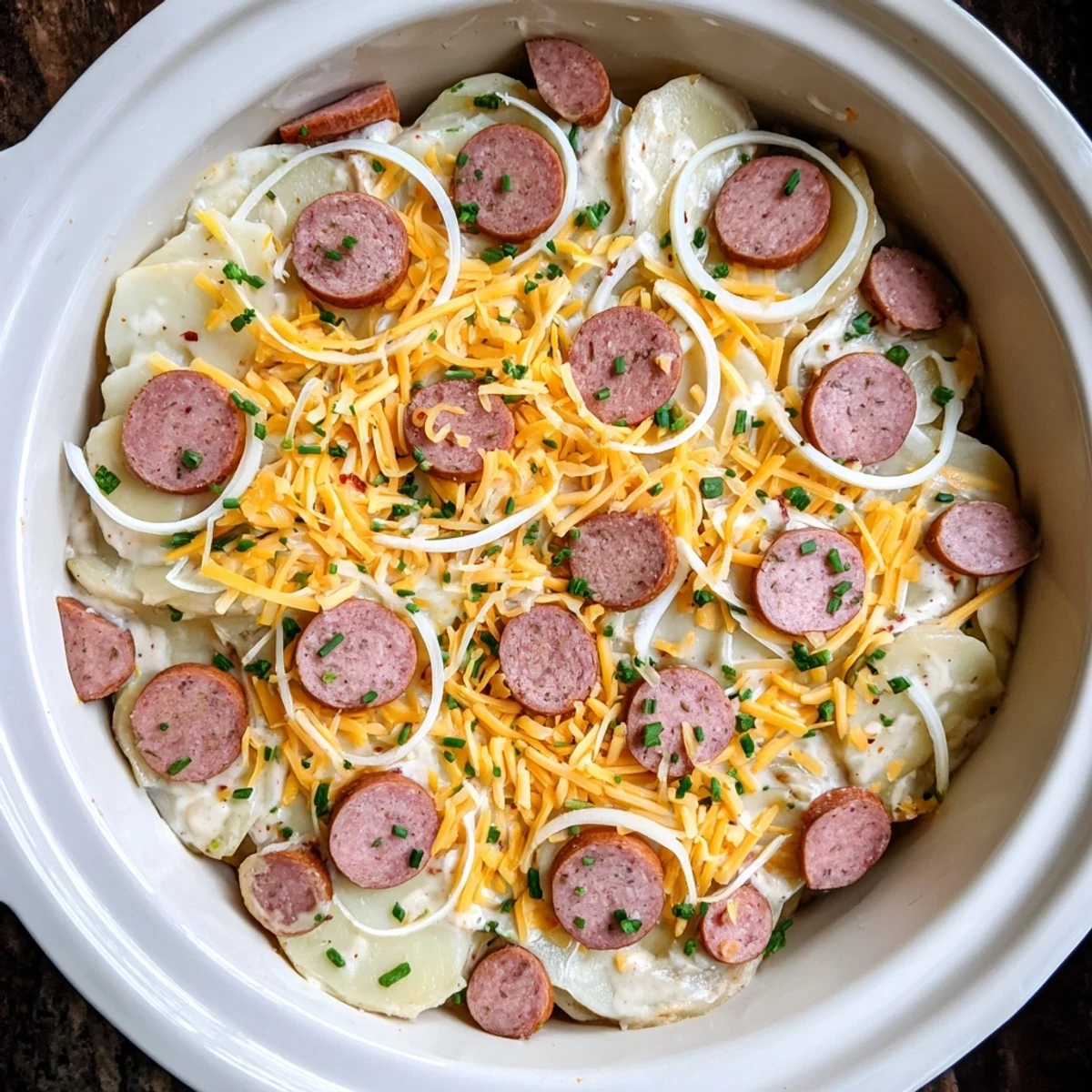 Hearty slow cooker dish with plump potato pierogi nestled between savory kielbasa rounds