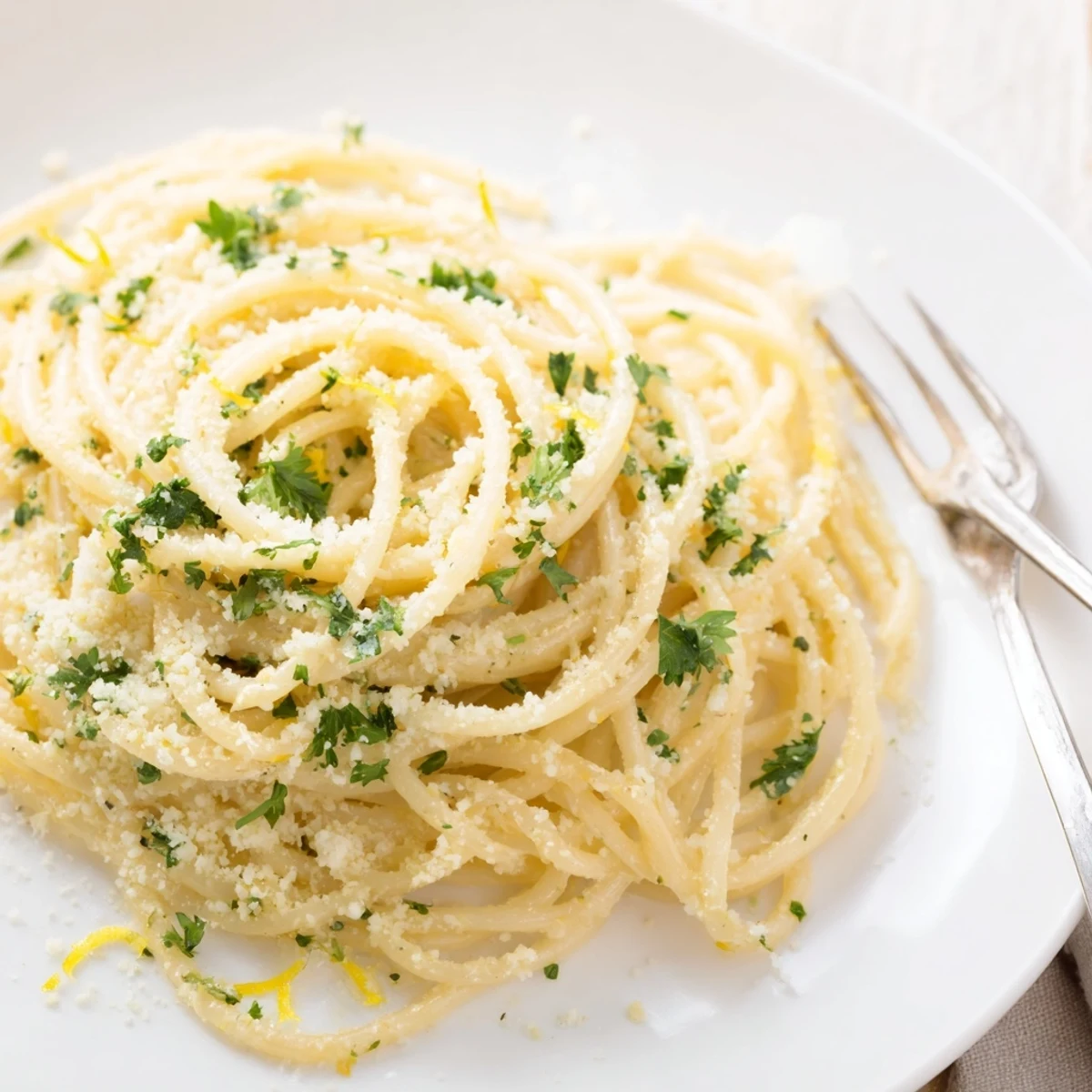 Creamy one pot garlic butter pasta tossed with parmesan and fresh parsley in a bowl
