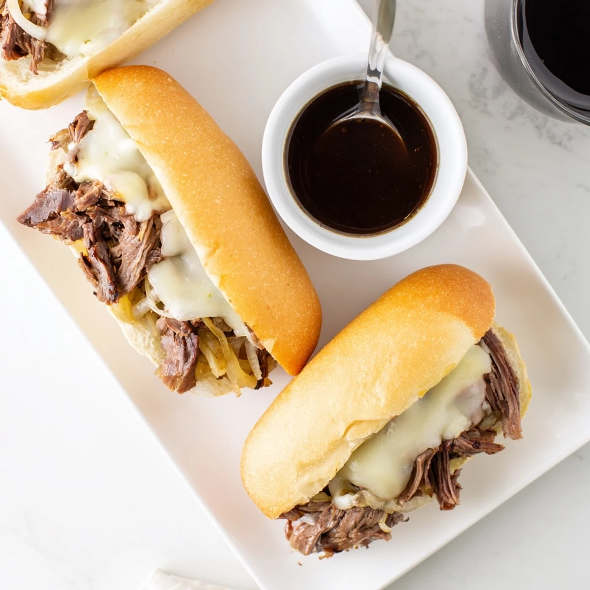 Hearty beef sandwiches on fresh bread with savory broth for Crockpot French Dip Sandwiches dinner