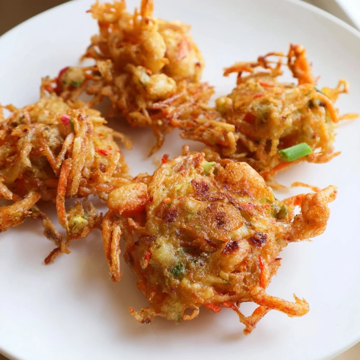 Ukoy Filipino shrimp fritters served hot with tangy vinegar garlic dipping sauce on the side