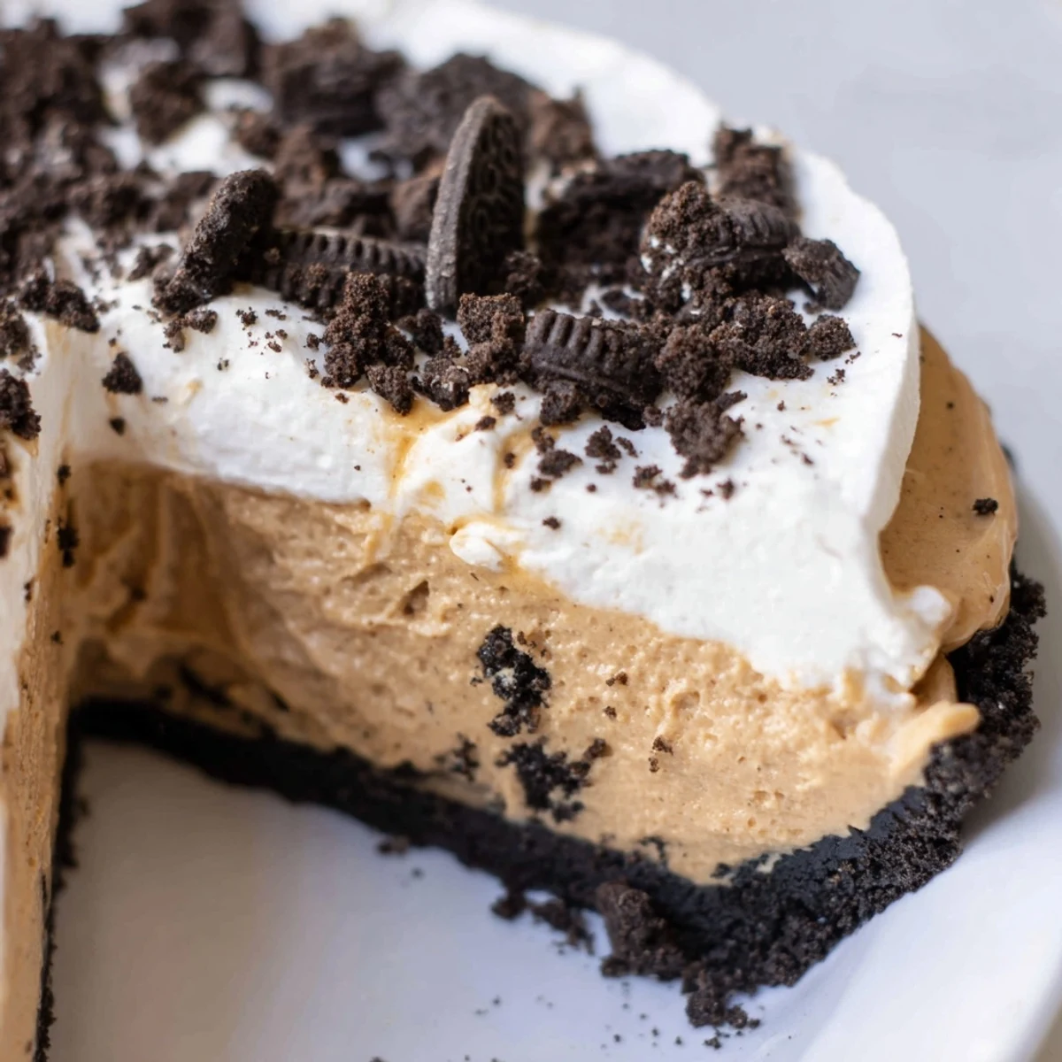 Silky peanut butter filling in chocolate Oreo crust topped with clouds of sweet whipped cream