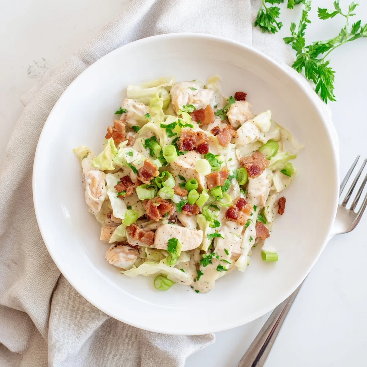 Crispy bacon and tender chicken in creamy ranch sauce over buttery sautéed cabbage