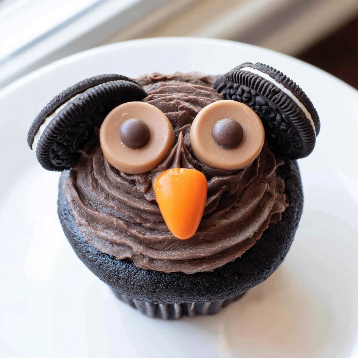 Adorable Oreo owl cupcakes with creamy frosting and chocolate candy eyes on rustic backdrop