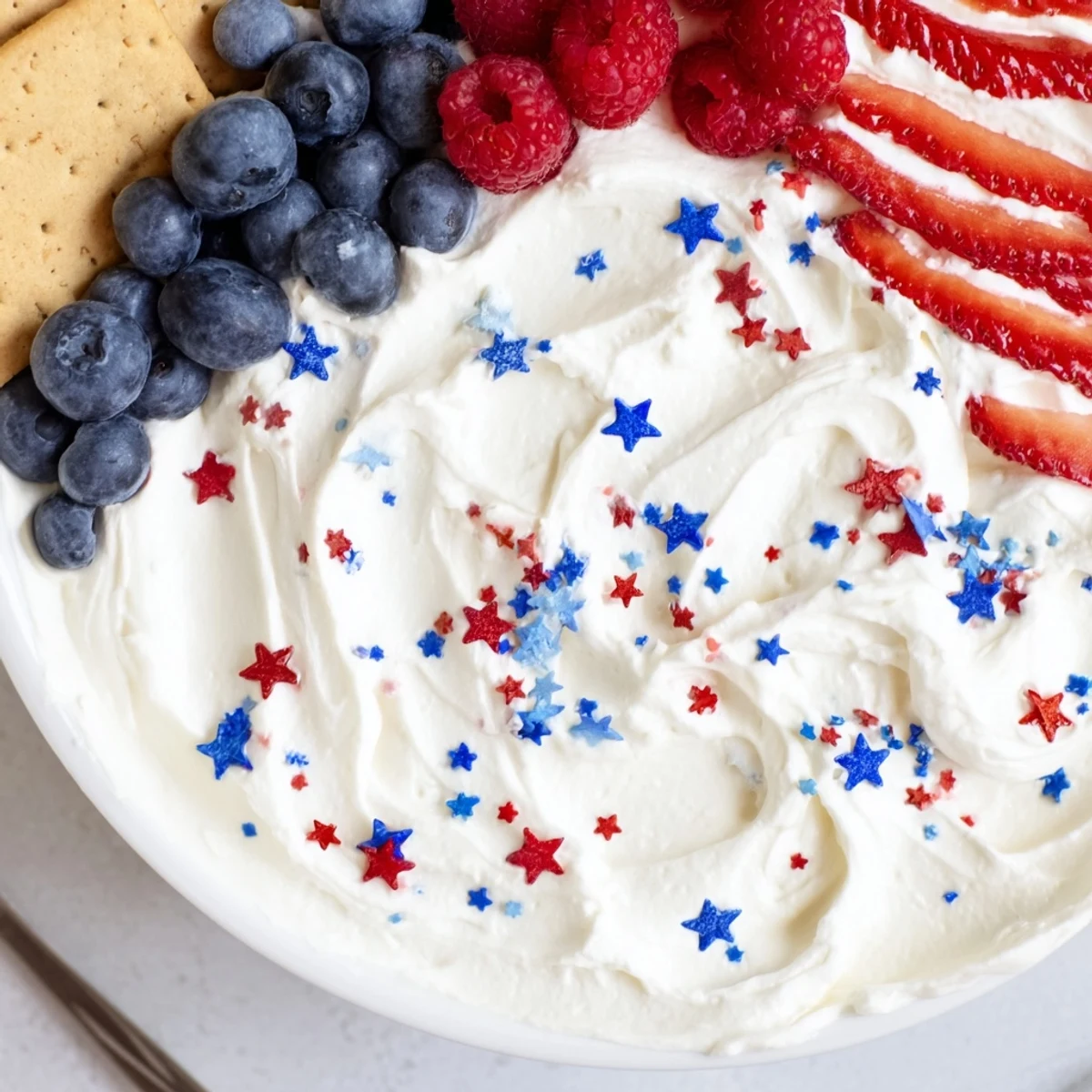 Patriotic appetizer plate featuring How To Make Star Spangled Cheesecake Dip with graham crackers