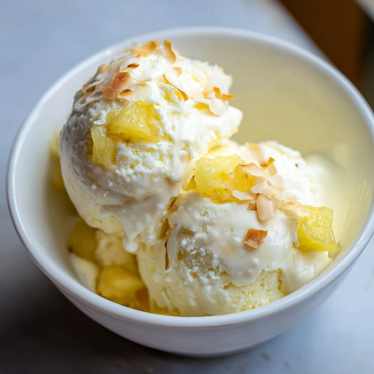 Homemade Creamy Pineapple Ice Cream cooling in freezer-safe container, tropical aroma