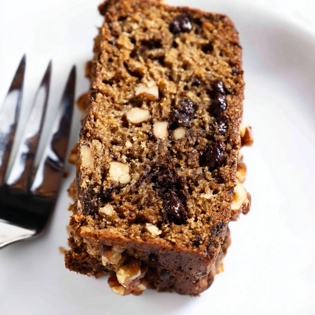 Wholesome protein banana bread oil free fresh from oven with steam rising and crumbs on cutting board