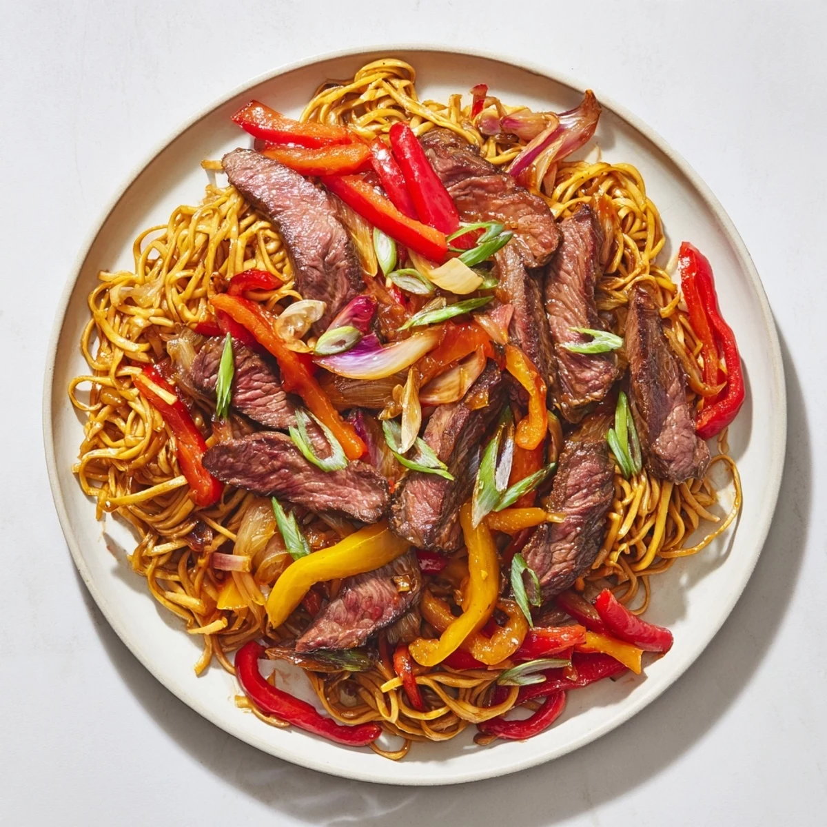 Classic beef chow mein featuring crisp vegetables and tender beef on a serving platter