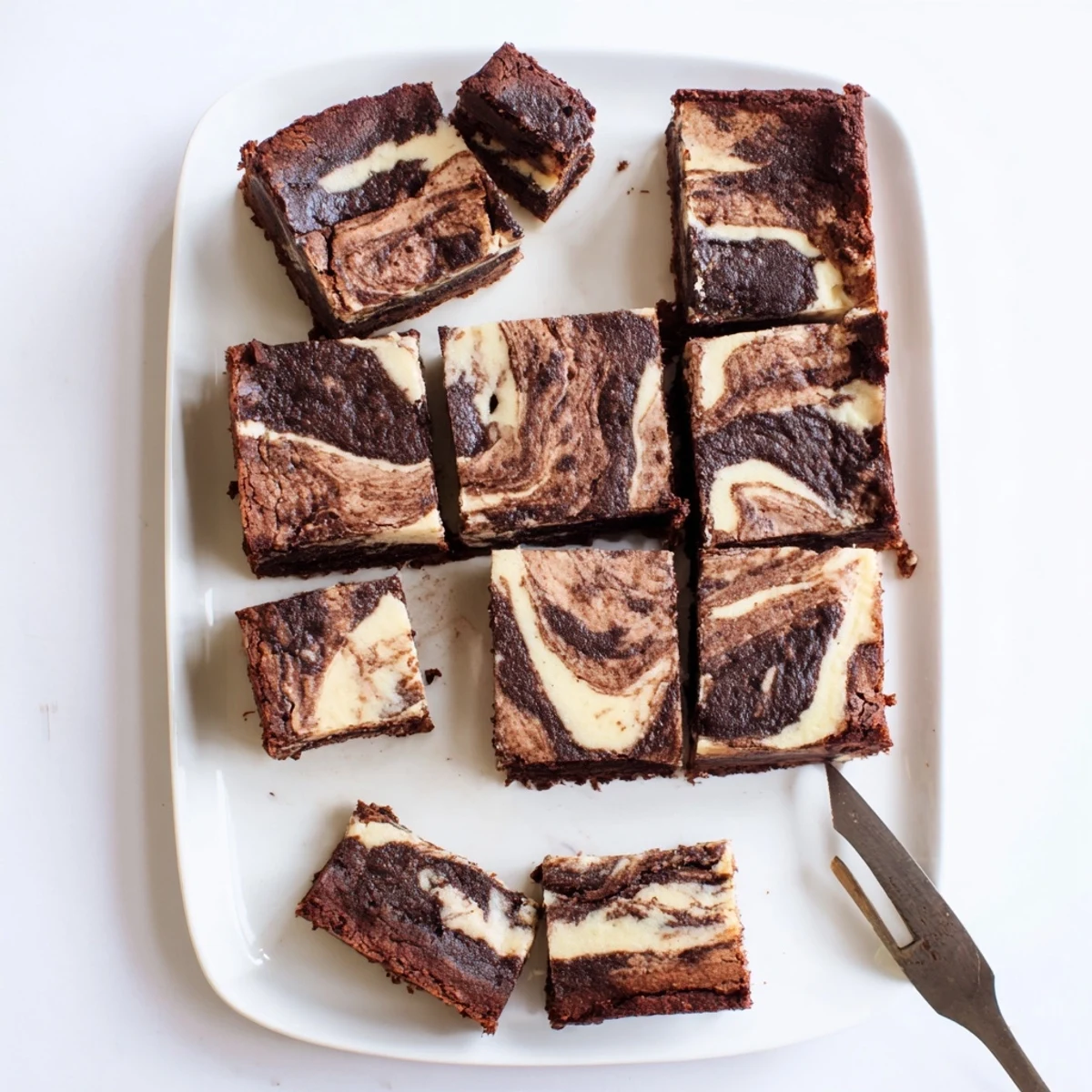 Marbled chocolate and cream cheese sourdough brownie bars stacked for serving