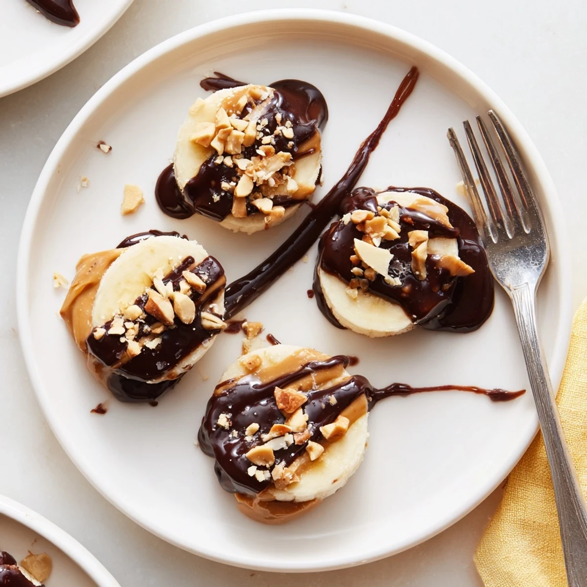 Frozen bites of Chocolate Peanut Butter Banana, crunchy peanut topping and melted chocolate
